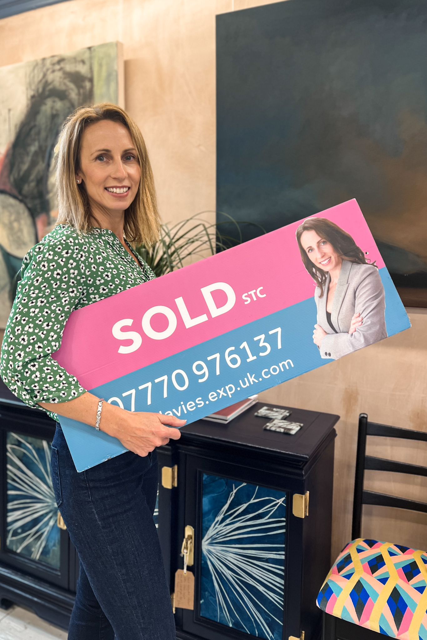 Photo of agent holding a sold board